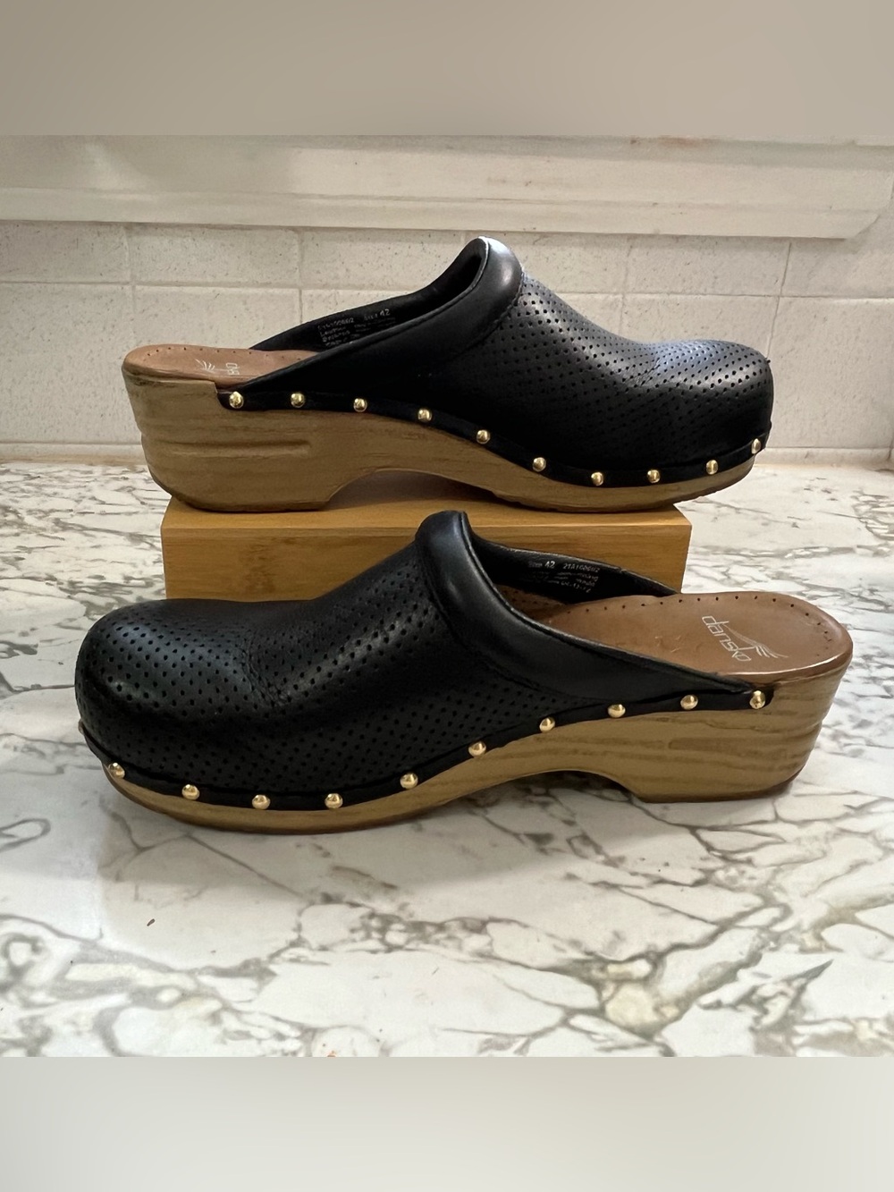 Dansko Perfed Pro Black Perforated Leather Clogs with Wood-Effect Platform.